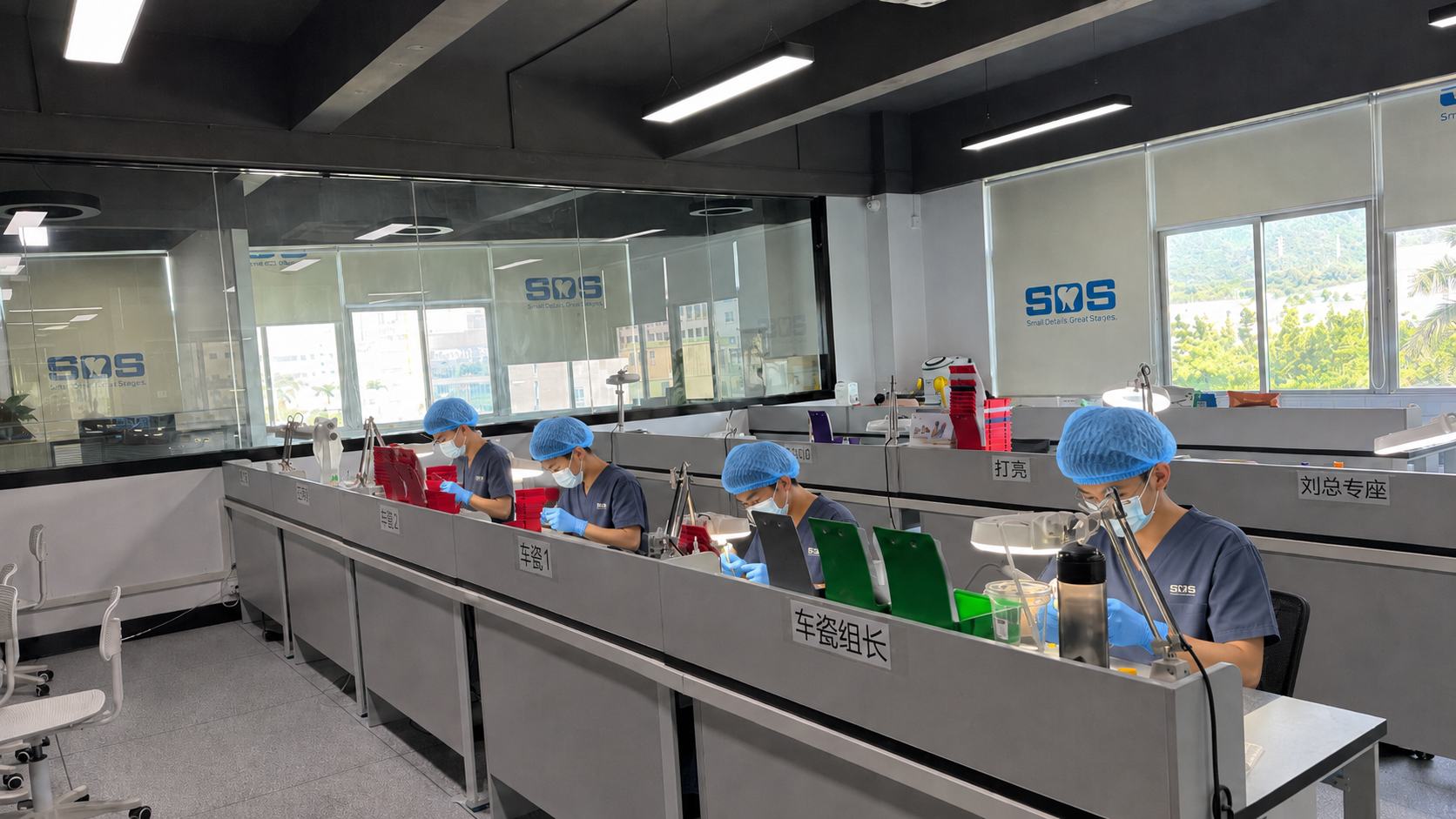 dental laboratory technicians working in a ceramic processing workshop